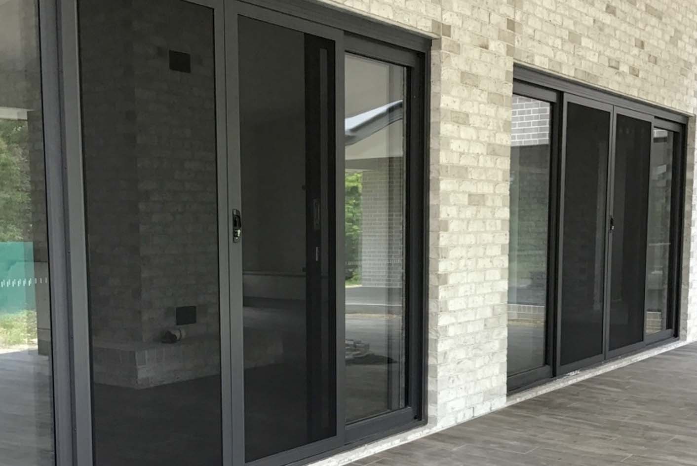 Multiple sliding security screens installed on a home for bushfire protection