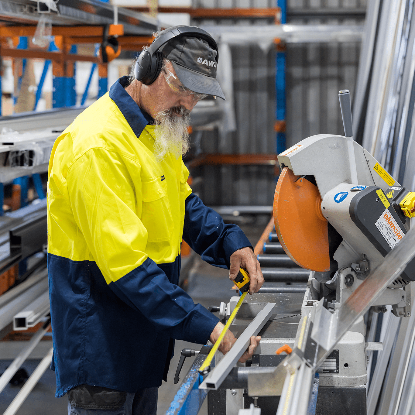 Eversafe technician measuring and cutting aluminium framing in the workshop